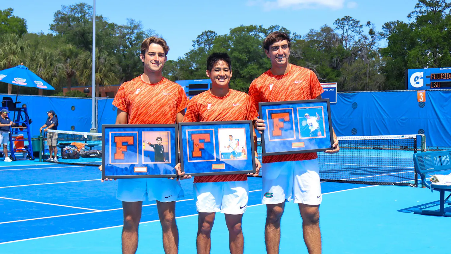 Pablo Perez Ramos, Tanapatt Nirundorn, and Lorenzo Clavier accept plaques honoring their time on the Florida Men's Tennis team at their senior night game against Louisiana State, Saturday, April 4, 2026, in Gainesville, Fla.