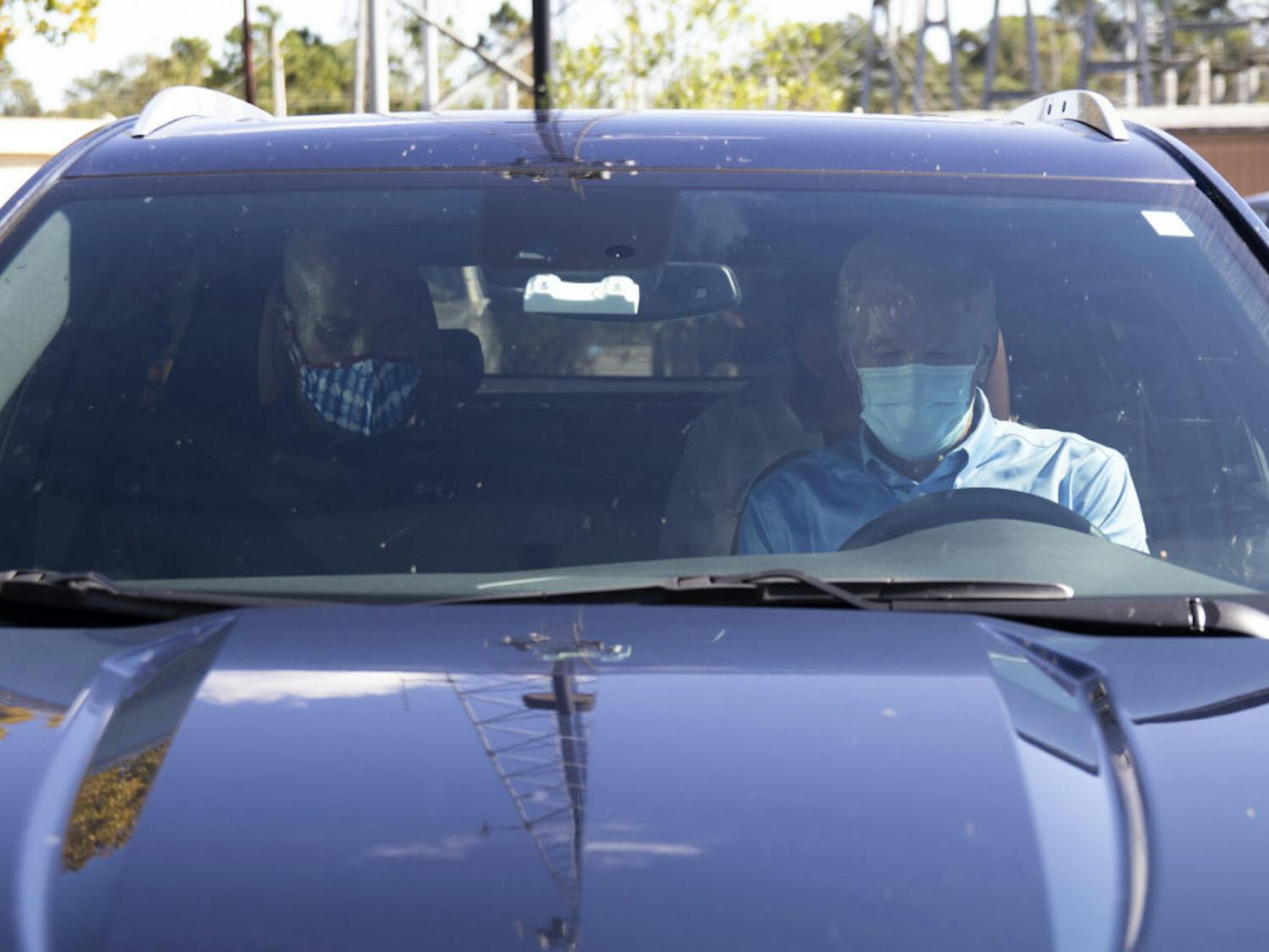 Senator Cory Booker and former Senator Bill Nelson sit in a car, preparing to leave the parking lot after the “Good Trouble” rally at Depot Park on Saturday, Oct. 31, 2020.