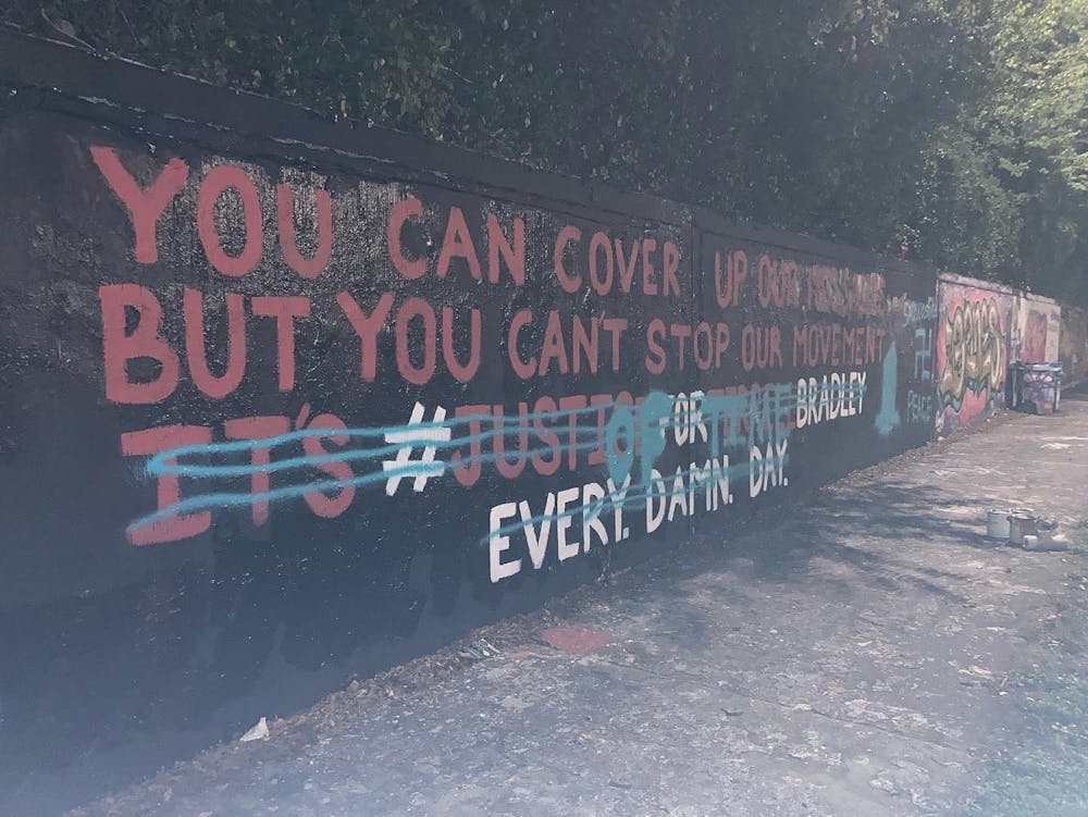 <p>The mural on Southwest 34th Street is shown defaced with blue spray paint depicting a swastika and the phrase, “God Bless Derek Chauvin.&quot;</p>