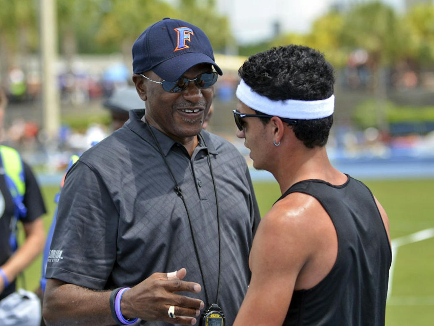 UF coach Mike Holloway talks with Andres Arroyo during the Florida Relays on April 4, 2015, at the Percy Beard Track.