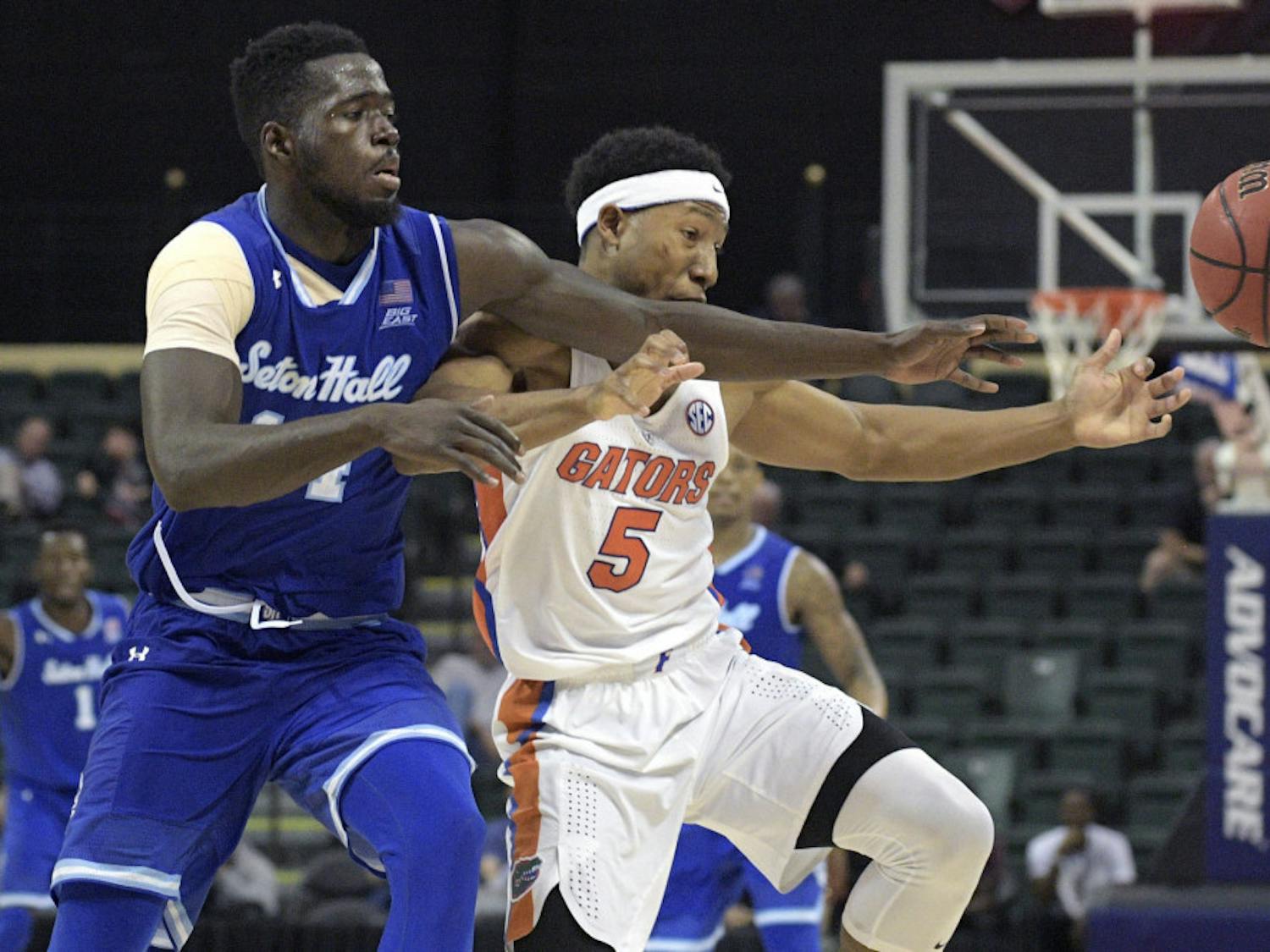 Seton Hall forward Ismael Sanogo, left, and Florida guard KeVaughn Allen (5) reach for the ball during the second half of an NCAA college basketball game in Lake Buena Vista, Fla., Thursday, Nov. 24, 2016. Florida won 81-76. (AP Photo/Phelan M. Ebenhack)