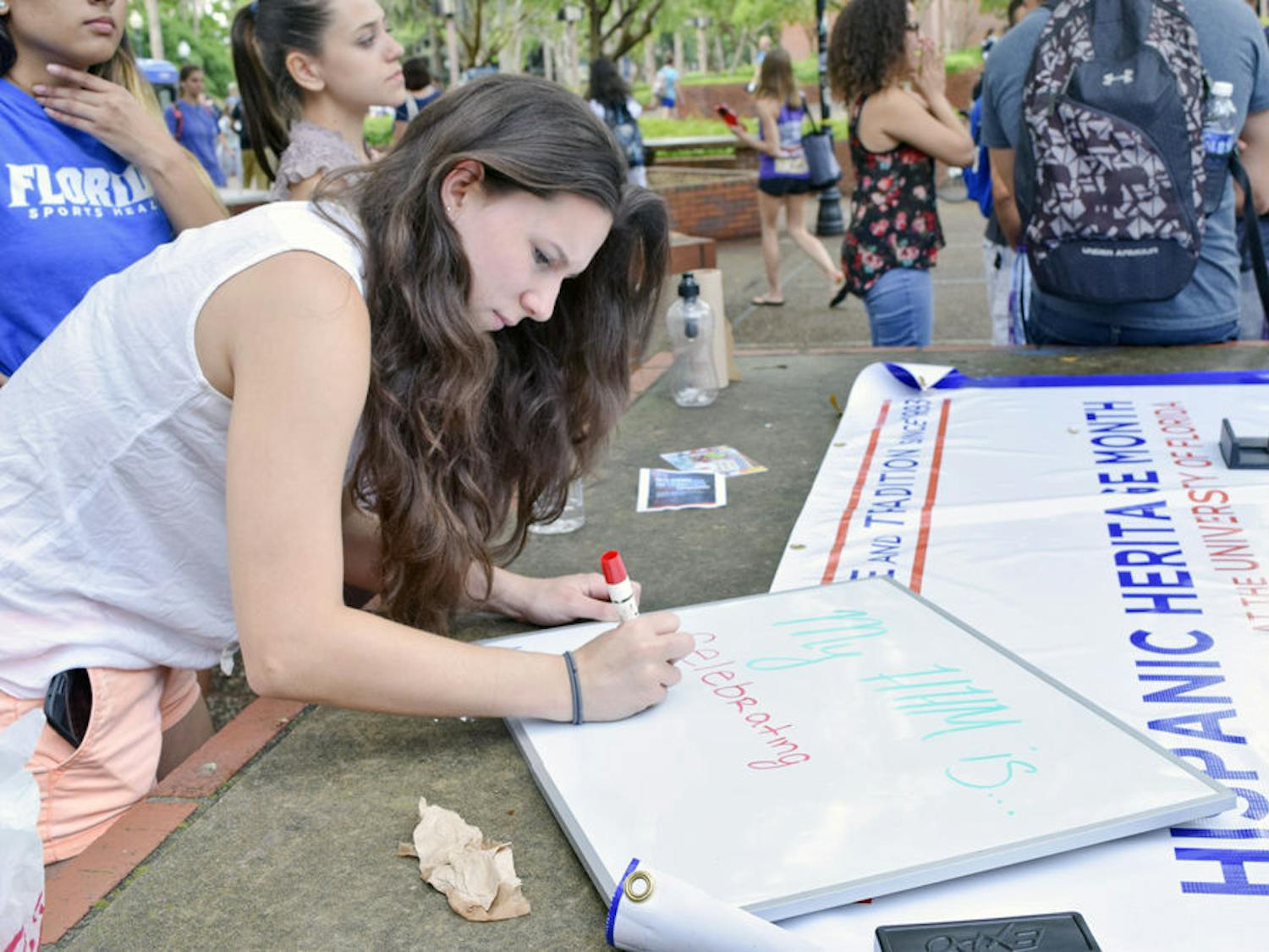 Jordan Fulkerson,​ an 18-year-old UF public relations freshman, writes down what Hispanic Heritage Month means to her at an HHM Week tabling event on Turlington Plaza on Monday. HHM will host events throughout the week to introduce students to HHM and give them a glimpse of what the upcoming month will be like.
Correction: The original byline was incorrect - Samantha Pollack.&nbsp;