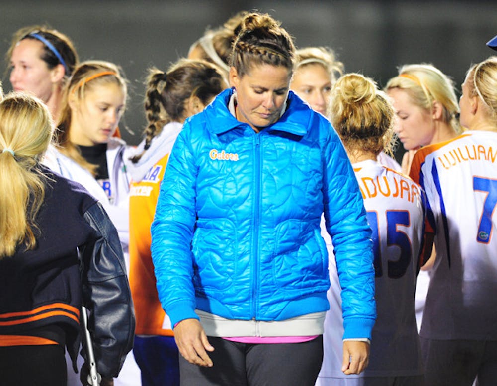 <p>Coach Becky Burleigh walks off the field after losing to UCF 3-2 on Friday. The loss ended the Gators’ season in the second round of the NCAA tournament for the third year in a row.</p>