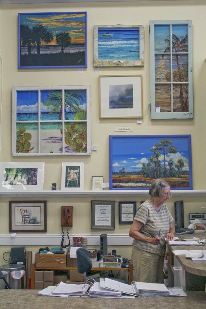 Nancy Gildersleeve, 76, the artist on duty at the Artisan's Guild Gallery, works at the artist's co-op Wednesday afternoon. Its current theme is "Fresh From Florida," in which each artist in the gallery has a piece that encapsulates the Florida theme.