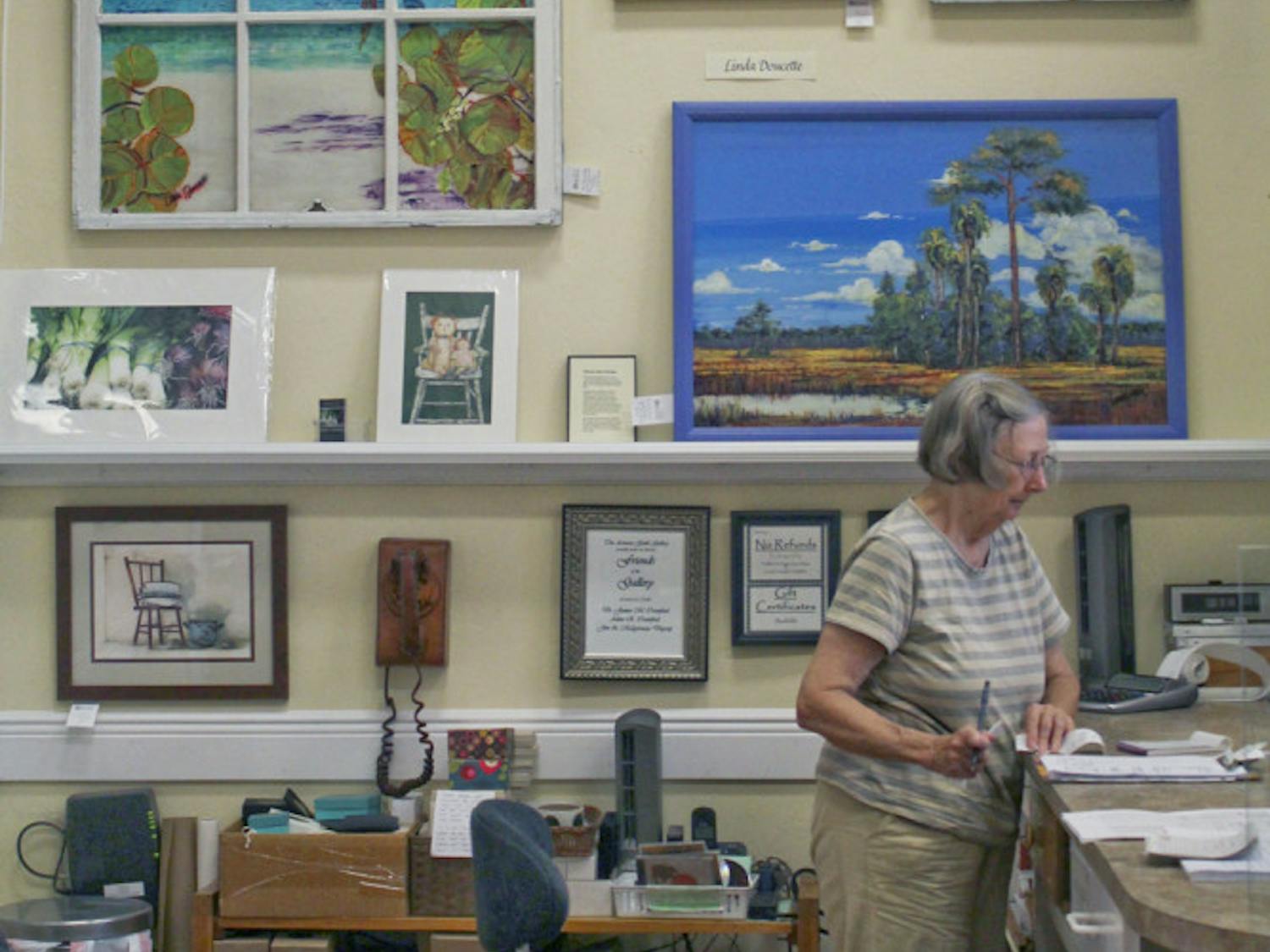 Nancy Gildersleeve, 76, the artist on duty at the Artisan's Guild Gallery, works at the artist's co-op Wednesday afternoon. Its current theme is "Fresh From Florida," in which each artist in the gallery has a piece that encapsulates the Florida theme.