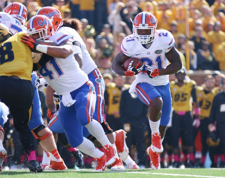 Kelvin Taylor (21) runs the football during Florida’s 36-17 loss to Missouri on Saturday at Faurot Field in Columbia, Mo. Taylor, a freshman running back, gained 74 rushing yards and scored the first touchdown of his college career on 12 attempts against the unbeaten Tigers.