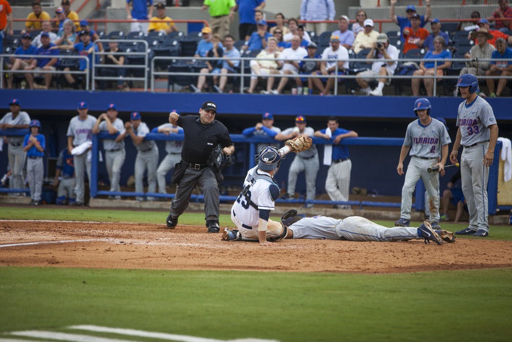 <p>UF shortstop Richie Martin is tagged out at home plate by UNC catcher Korey Dunbar during Florida's 5-2 loss on Saturday at McKethan Stadium. The loss eliminated the Gators from the NCAA Tournament.</p>