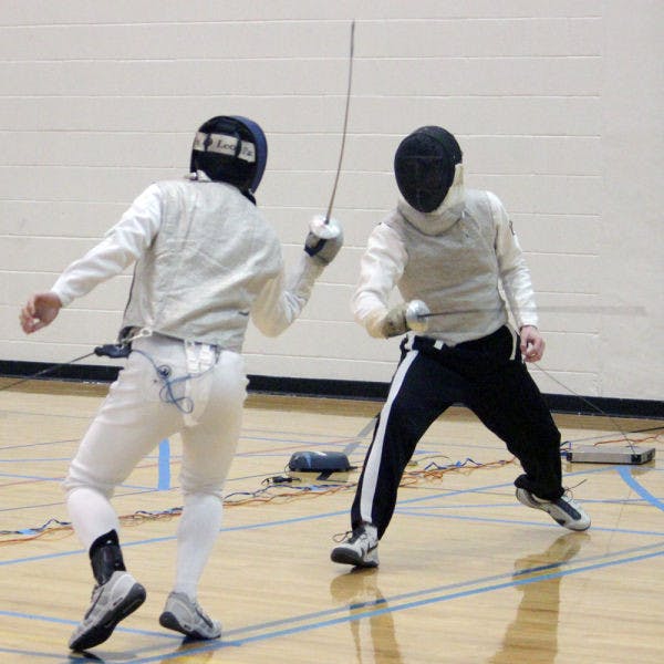 Todd Kozlowski, a 21-year-old UF physics and astronomy junior, warms up for the foil competition in the 48th annual Green Gator Fencing Tournament with Timothy Kierzkowski, a 20-year-old Georgia Tech math junior, this weekend.