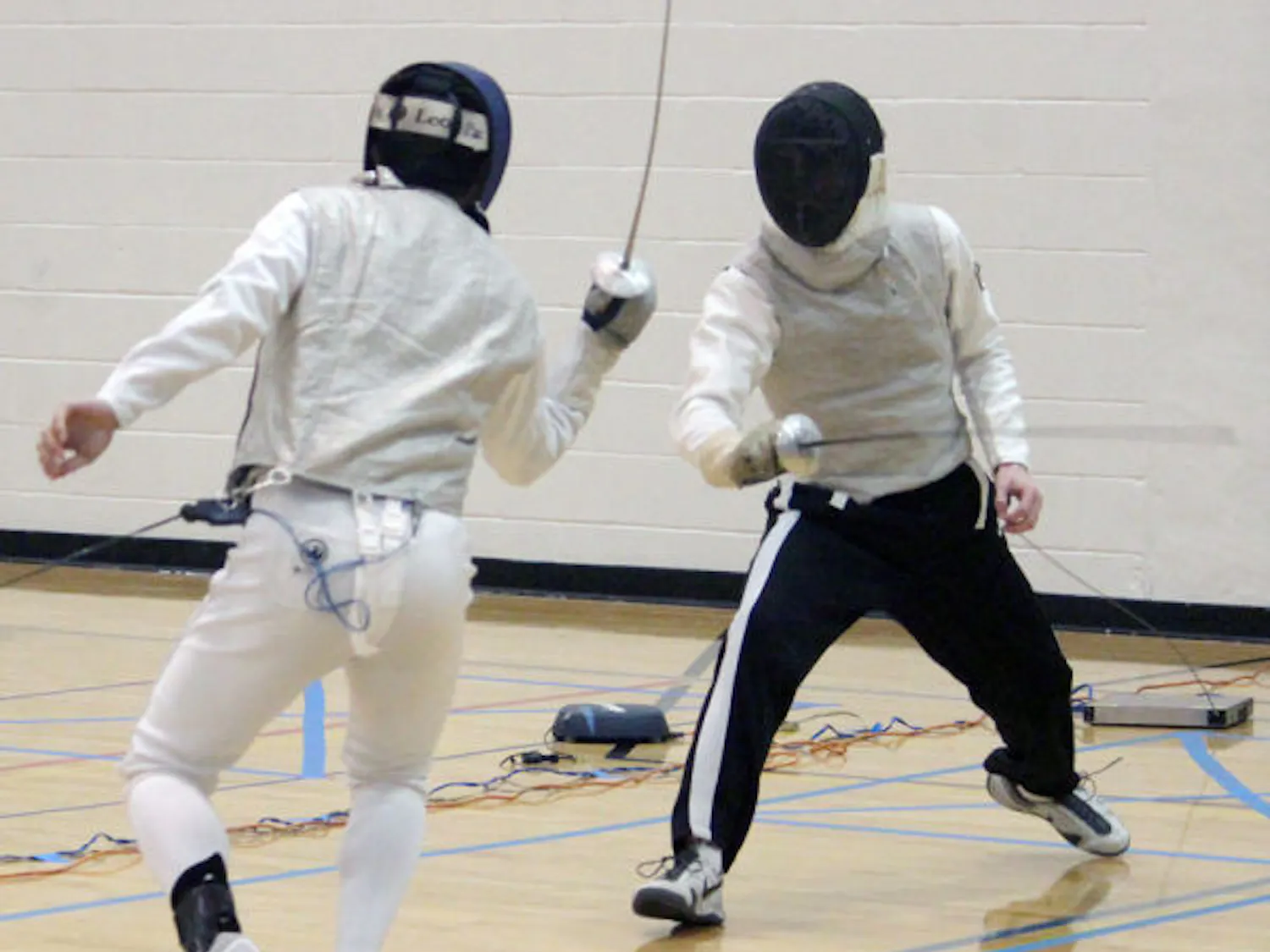 Todd Kozlowski, a 21-year-old UF physics and astronomy junior, warms up for the foil competition in the 48th annual Green Gator Fencing Tournament with Timothy Kierzkowski, a 20-year-old Georgia Tech math junior, this weekend.