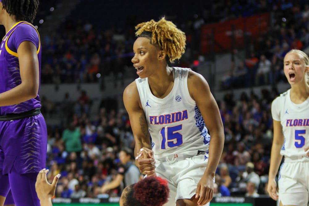 Florida guard Nina Rickards helps fellow UF guard KK Deans stand up during the Gators’ 90-79 loss to the Louisiana State Tigers Sunday, Feb. 19, 2023.