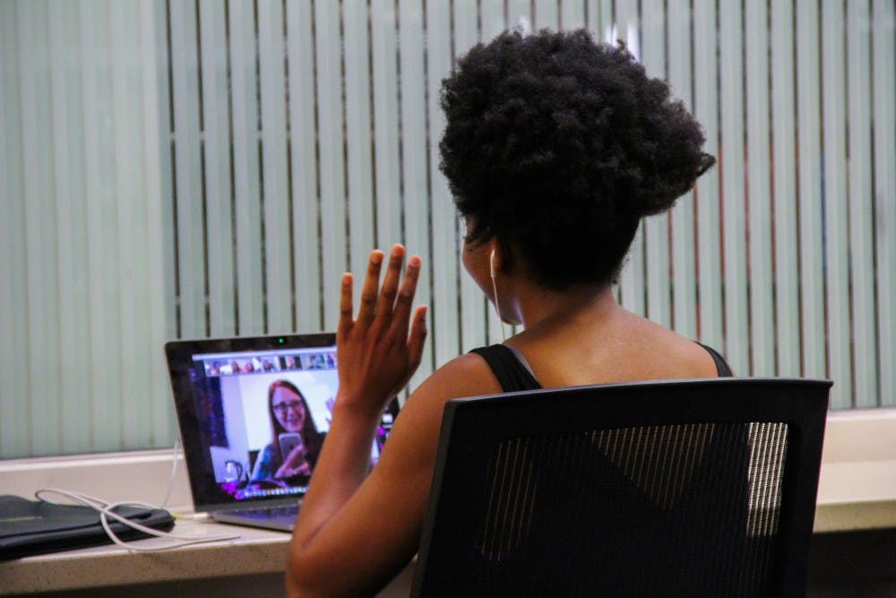 Nomfumo Manaba, a 23-year-old UF journalism and political science junior, video calls into her class at Library West. 