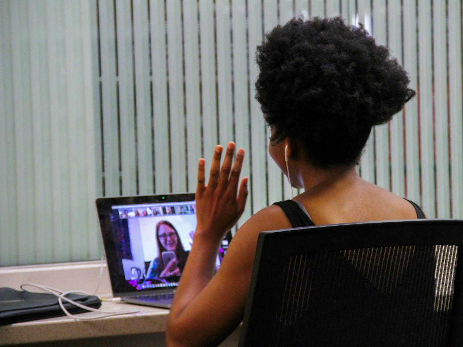 Nomfumo Manaba, a 23-year-old UF journalism and political science junior, video calls into her class at Library West.