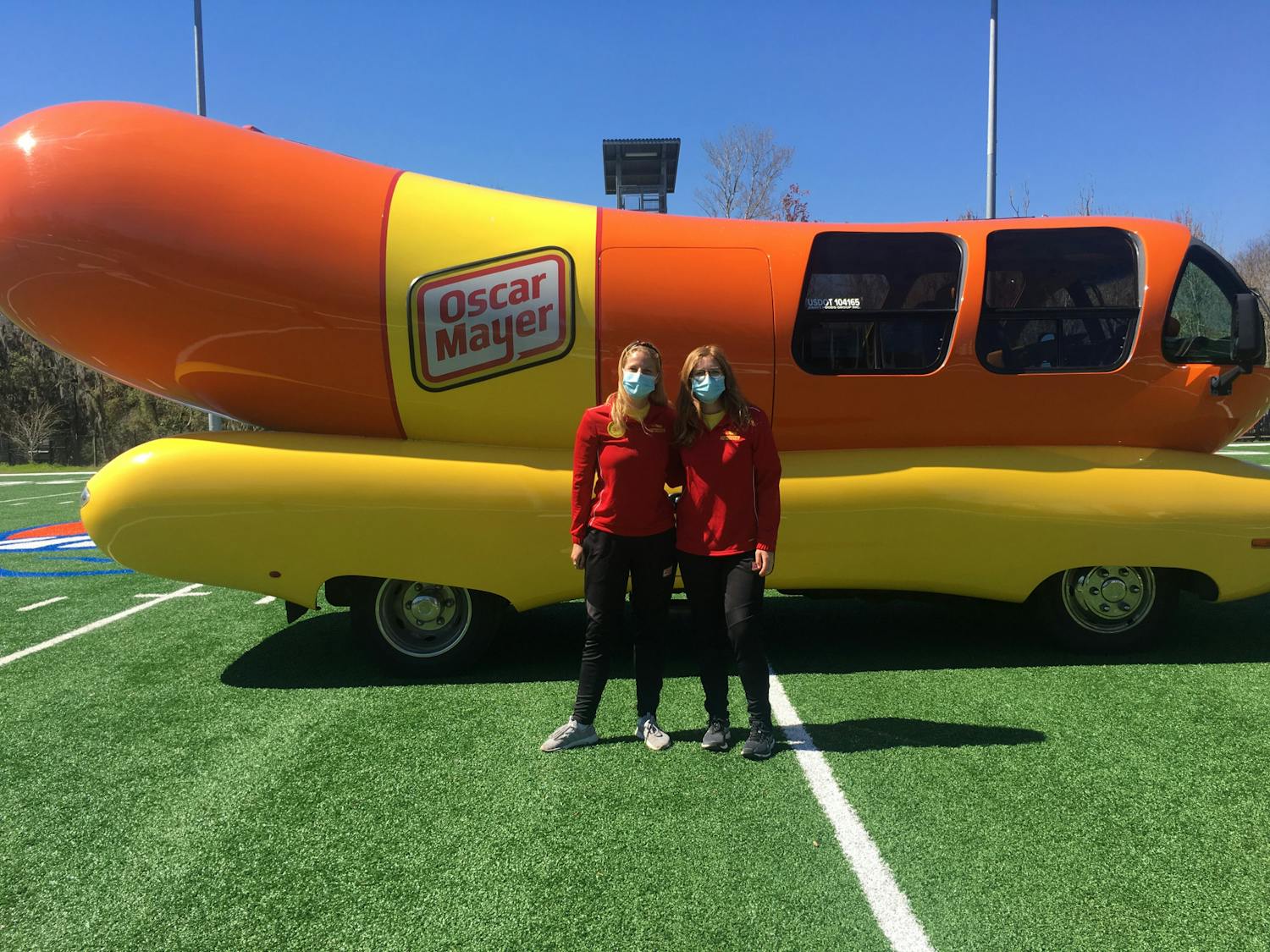 Molly Swindall, left, and Maggie Thomas, right, two of the 12 hotdoggers of Class 33, arrived at UF in the Wienermobile to recruit the next class of hotdoggers.