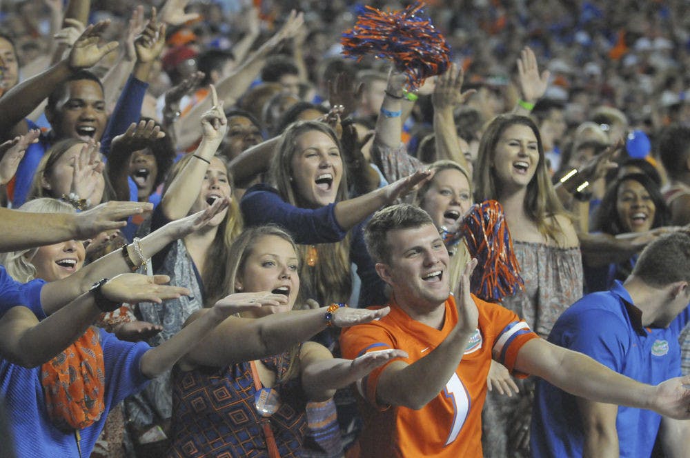 <p>UF fans do the Gator Chomp during Florida's 27-2 loss to Florida State on Nov. 28, 2015, at Ben Hill Griffin Stadium.</p>