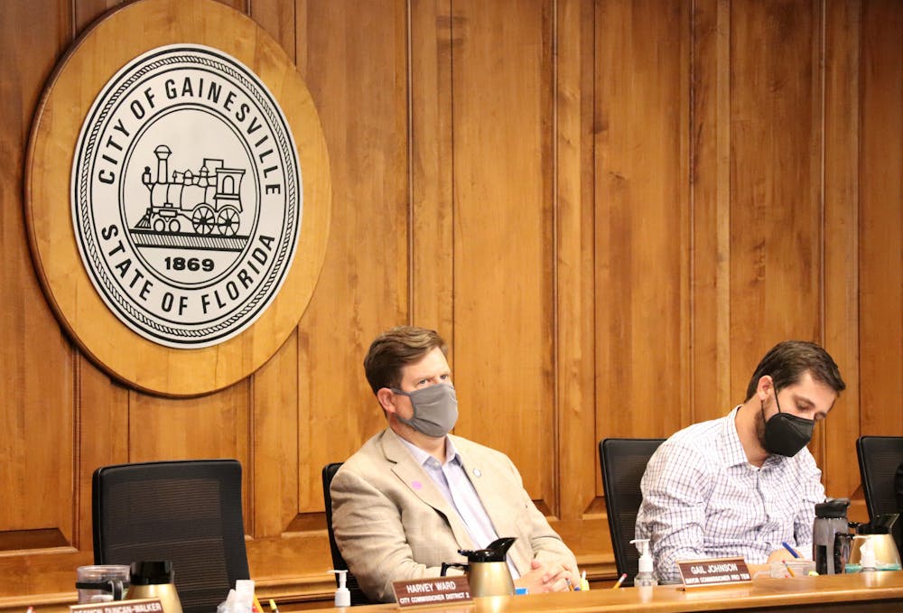 <p>Gainesville Mayor Lauren Poe (left) and City Commissioner Adrian Hayes-Santos (right) listen to public comment at a City Commission meeting on Monday, Sept. 27, 2021.</p>