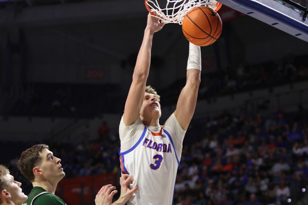 Sophomore center Micah Handlogten dunks the ball in the Gators' 93-73 win against the Loyola Greyhounds on Monday, Nov. 6, 2023. 