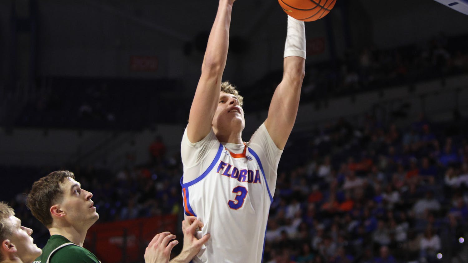 Sophomore center Micah Handlogten dunks the ball in the Gators' 93-73 win against the Loyola Greyhounds on Monday, Nov. 6, 2023. 
