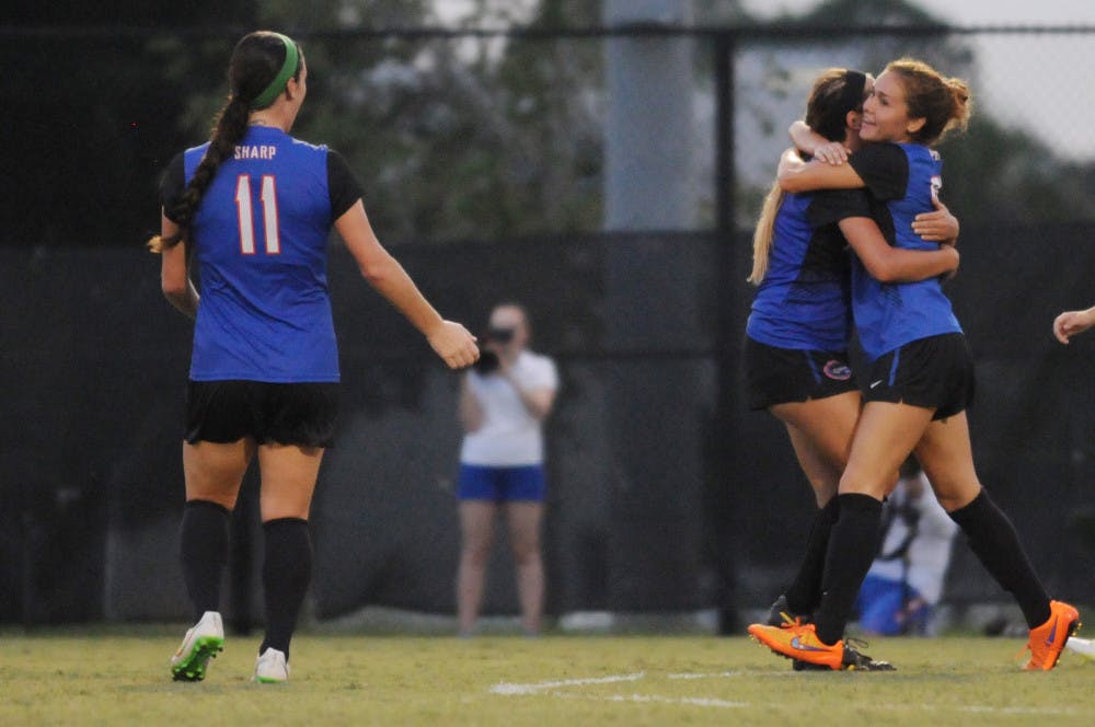 UF midfielder Mayra Pelayo hugs teammate Kristen Cardano after Pelayo scored the equalizer during Florida's 2-1 win against Troy in an exhibition match on Aug. 11, 2015, at the soccer practice field at Donald R. Dizney Stadium.
