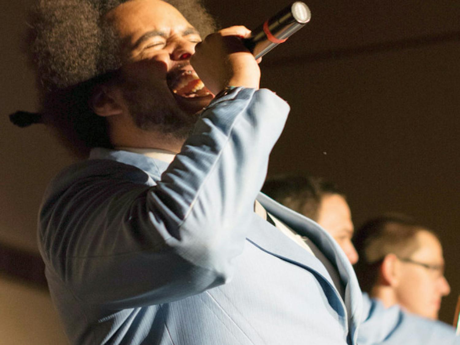 Justin McKenzie, the 25-year-old lead male singer, sings with his band The Savants of Soul in the Reitz Union Grand Ballroom on Tuesday night. The Savants of Soul are a 10-member local band that plays soul music.