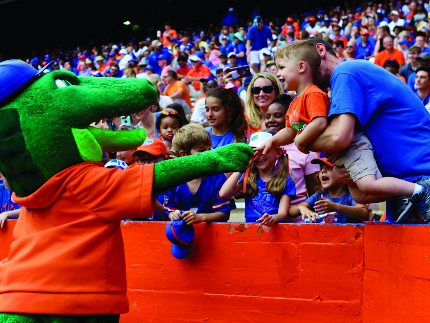 Albert E. Gator greets a young Gator fan during the Orange &amp; Blue football game in January 2019. The scrimmage held at Ben Hill Griffin Stadium had 53,015 in attendance.