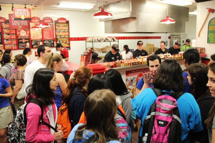 Customers wait in a crowded line in the Firehouse Subs on University Avenue early Tuesday evening. Firehouse gave out free subs to promote its new healthy menu.