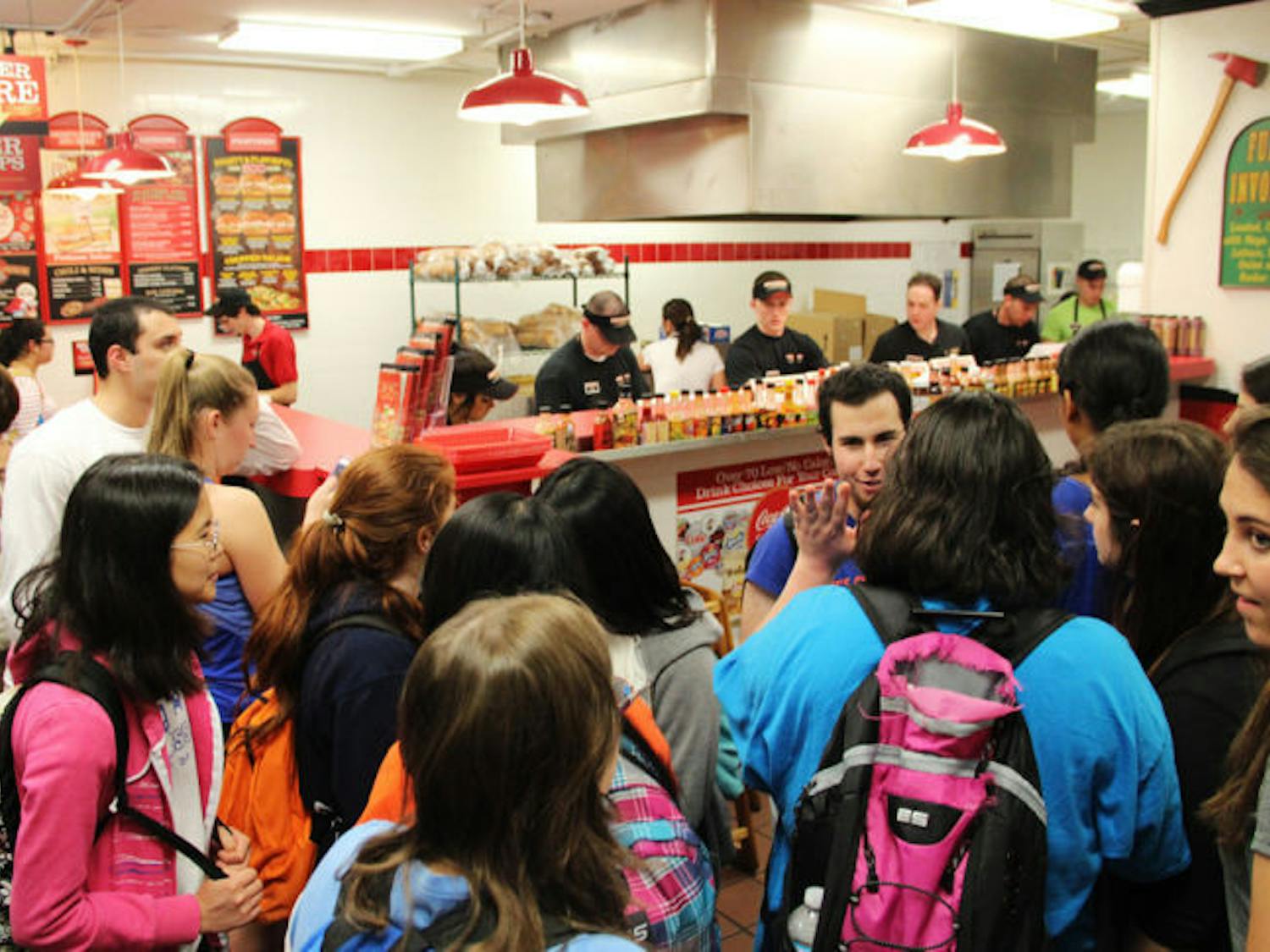 Customers wait in a crowded line in the Firehouse Subs on University Avenue early Tuesday evening. Firehouse gave out free subs to promote its new healthy menu.