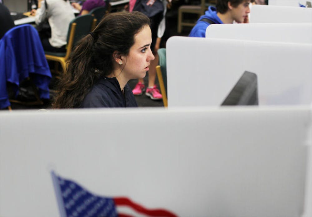 <p>UF international studies and political science double major Elizabeth DiVito, 18, casts her vote Tuesday afternoon at the Marston Science Library. About 6,270 ballots were counted on the first day of voting.</p>