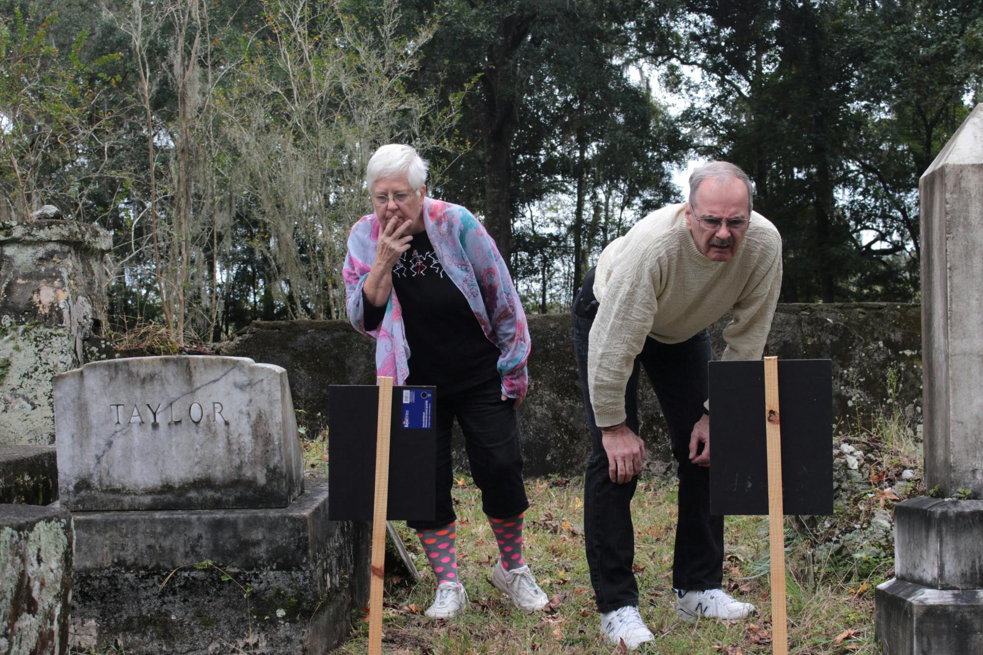 Linda and Robert Kasicki look at some of the oldest graves in Kanapaha Presbyterian Church Cemetery on Sunday, Oct. 31, 2021.