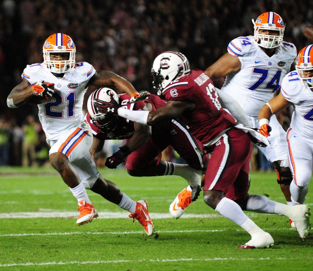 Running back Kelvin Taylor (21) rushes for a touchdown during Florida’s 19-14 loss to South Carolina on Nov. 16 at Williams-Brice Stadium in Columbia, S.C.