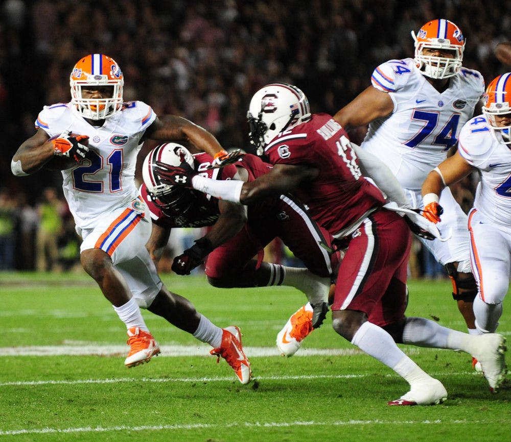 <p class="p1">Running back Kelvin Taylor (21) rushes for a touchdown during Florida’s 19-14 loss to South Carolina on Nov. 16 at Williams-Brice Stadium in Columbia, S.C.</p>