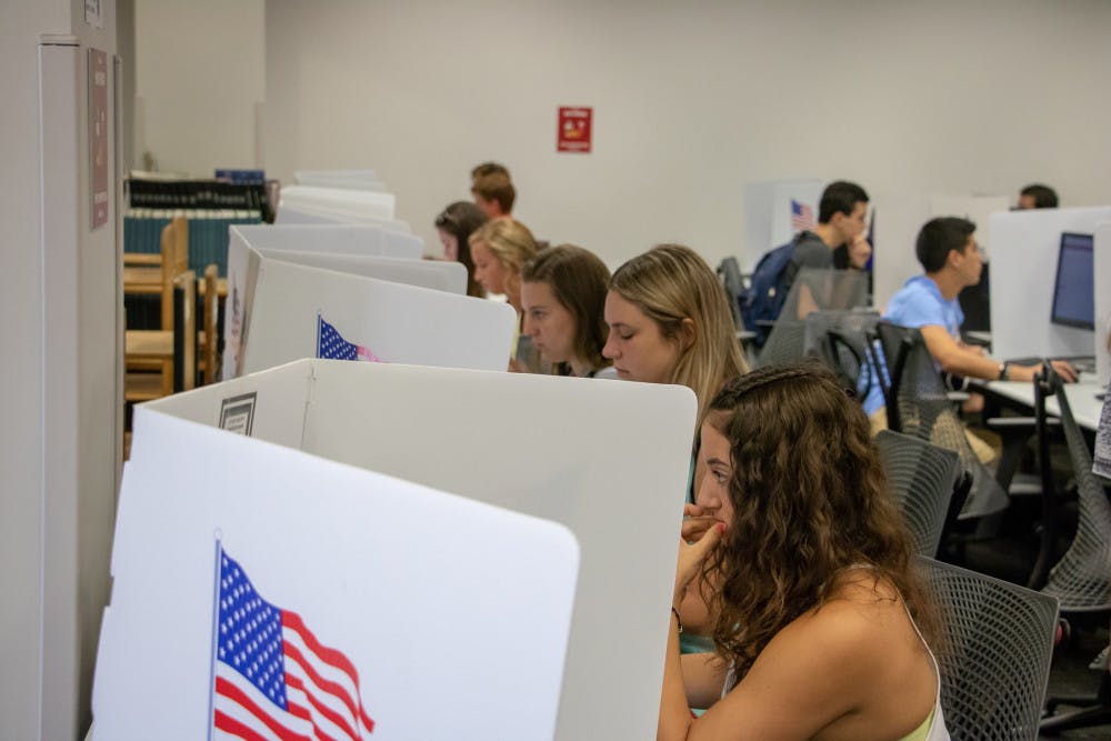 Students sit at voting stations at the Marston Science Library computer lab polling location and cast their votes for last Fall's Student Government elections on Sept. 25. Marston is one of several locations students can vote at on Wednesday. 