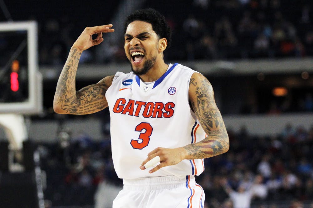 <p>Guard Mike Rosario celebrates after making a three-point shot during Florida's 62-50 win against Florida Gulf Coast in the NCAA Tournament Sweet 16 on Friday at Cowboys Stadium in Arlington, Texas. </p>