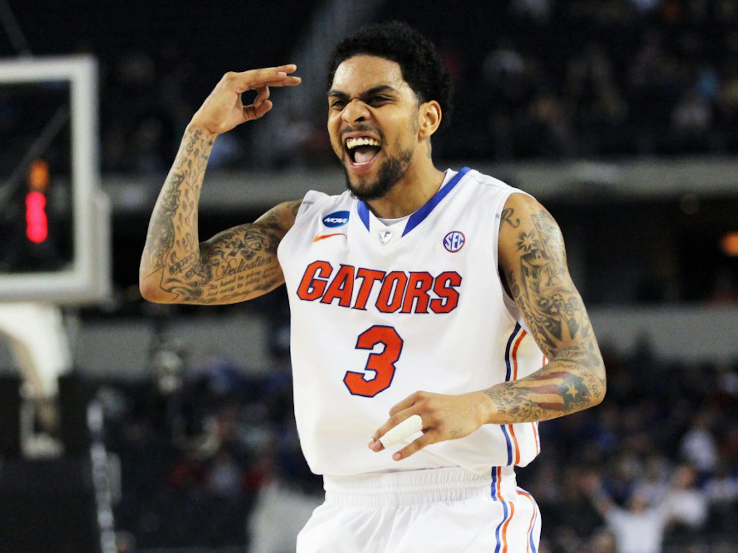 Guard Mike Rosario celebrates after making a three-point shot during Florida's 62-50 win against Florida Gulf Coast in the NCAA Tournament Sweet 16 on Friday at Cowboys Stadium in Arlington, Texas.