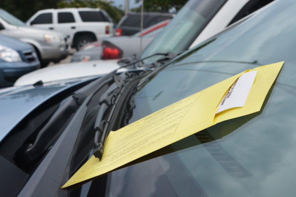 <p>A University Police parking ticket rests on a car’s windshield Monday. The city of Gainesville is attempting to collect more than $600,000 in unpaid tickets to provide revenue that could fund additional parking areas.</p>
<div>&nbsp;</div>