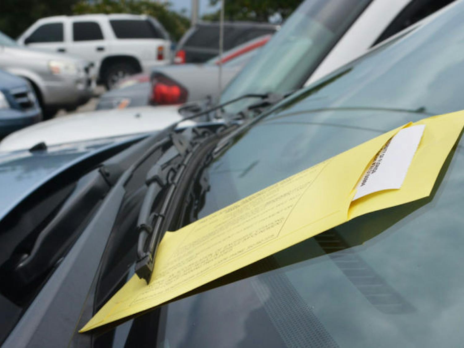 A University Police parking ticket rests on a car’s windshield Monday. The city of Gainesville is attempting to collect more than $600,000 in unpaid tickets to provide revenue that could fund additional parking areas.
