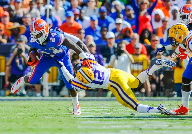 Matt Jones (24) stiff-arms LSU safety Corey Thompson (12) during Florida’s 17-6 loss on Oct. 12 at Tiger Stadium in Baton Rouge, La. Jones&nbsp;missed the season&nbsp;after suffering a torn meniscus in his left knee.