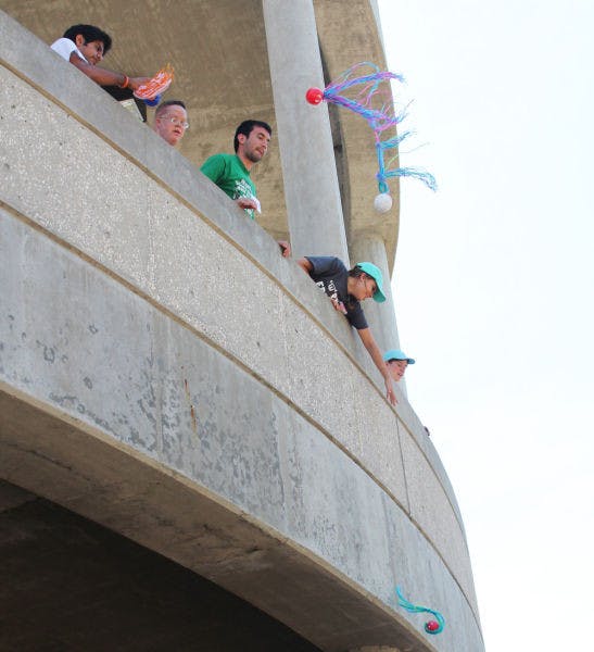 Sidney Lanier Fitness Program participants toss balls to each other Tuesday at the Ben Hill Griffin Stadium during their last workout session of the semester. The program will host a banquet Thursday in the Martial Arts Room of the Stephen C. O’Connell Center.