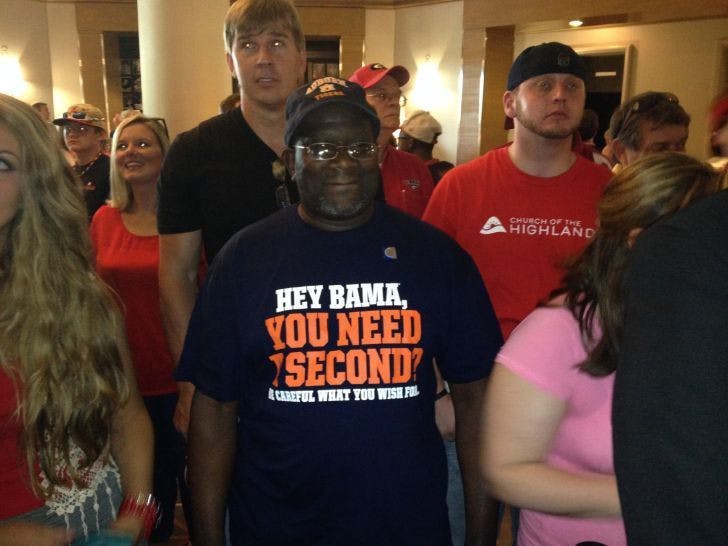 Auburn fan Jeff Moorer (center) waits in the lobby of the Hyatt Regency Birmingham on Thursday during the final day of the Southeastern Conference Media Days.