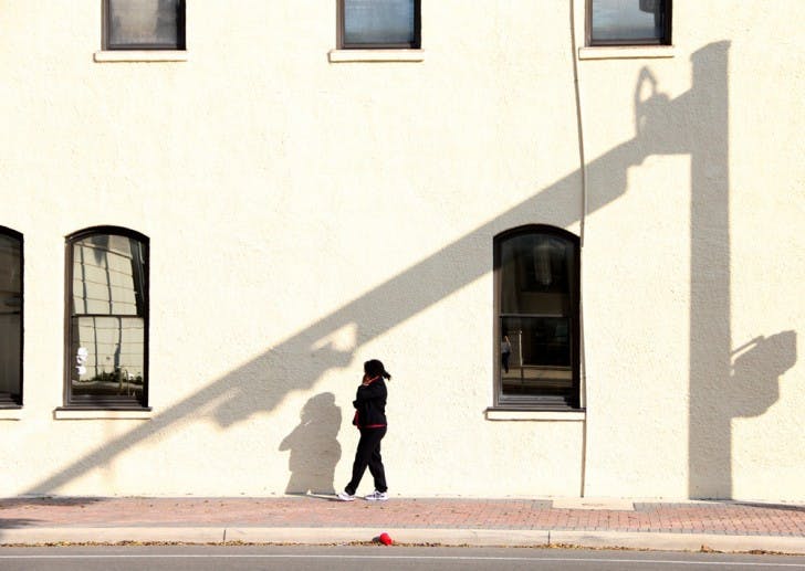 A woman walks and talks on her cellphone outside of the Alachua County Annex building, 10 SW Second Ave., Wednesday morning.