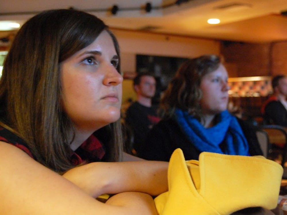 <p>Marketing freshman Jaclyn Gutierrez, left, 18, and journalism freshman Michelle Hiscock, 19, watch “Beautiful Losers” at Orange &amp; Brew during a film screening on Monday evening.</p>