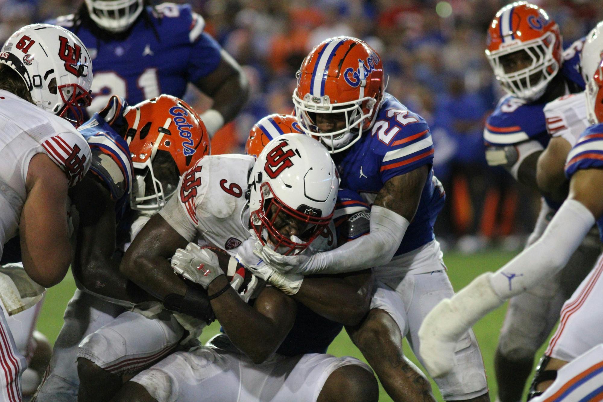 A pair of Florida defenders tackle the Utah tailback in the Gators' win over No. 7 Utah Sept. 3, 2022.