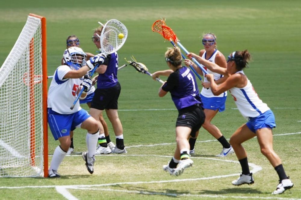 <p>Mikey Meagher (5) defends a goal against Northwestern on May 5, 2012. Coach Amanda O'Leary pulled Meagher in the second half of Florida's loss to Penn State to give the Gators an extra defender.</p>