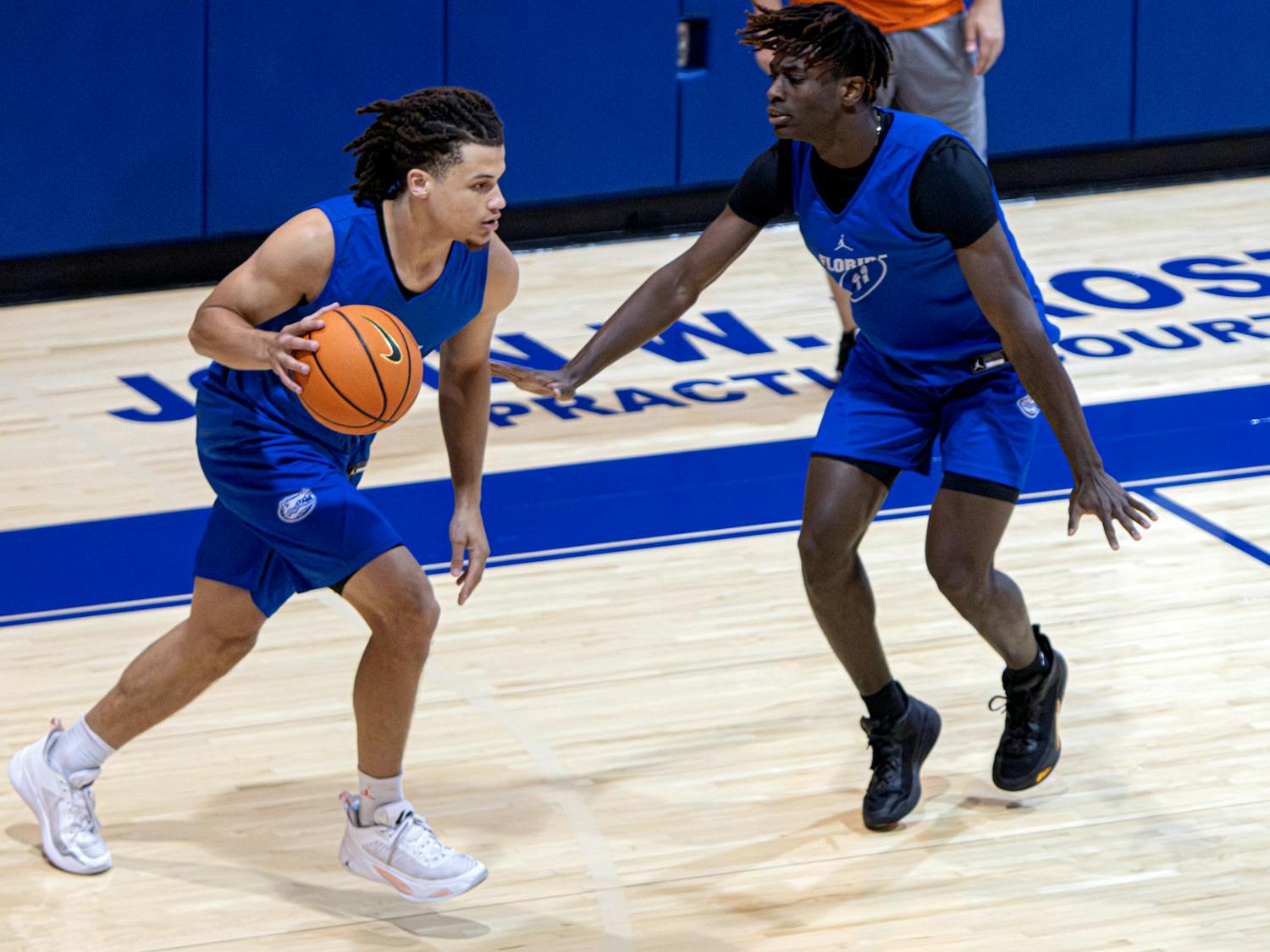 Junior guard Walter Clayton dribbles the ball against sophomore guard Denzel Aberdeen in Florida's open practice on Tuesday, Sept. 26, 2023.