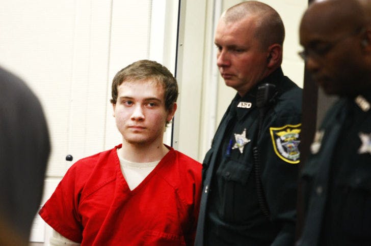 Pedro Bravo, 19, is led into the courtroom by Alachua County Sheriff’s Office deputies during Tuesday’s case management hearing at the Alachua County Courthouse.
