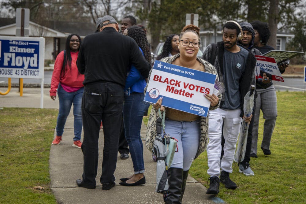 Fayetteville State University students and members of the Black Voters Matter organization at the Smith Recreation Center polling site in Fayetteville, N.C., on Tuesday, March 3, 2020. Fayetteville State students were there to vote in North Carolina's Super Tuesday primaries. (Paul Woolverton/The Fayetteville Observer via AP)