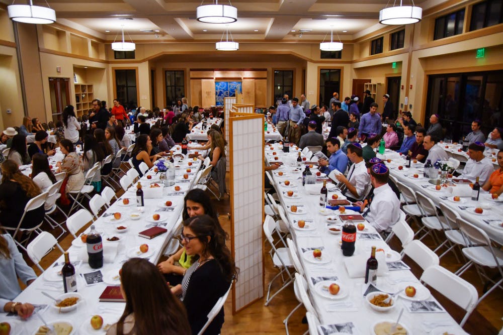 About 400 people attended the event at the Lubavitch-Chabad Jewish Student and Community Center on Sunday evening. Men and women sat at opposite ends of the room for the holiday service and dinner.