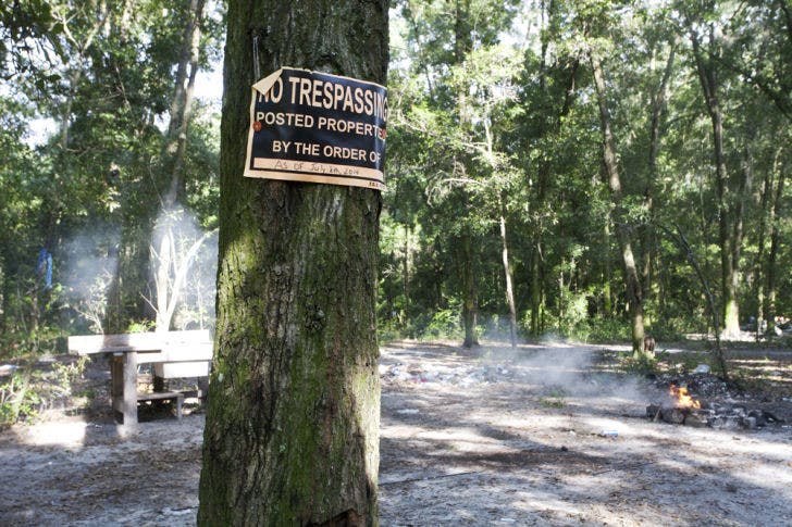 A sign posted by the Gainesville Police declares the date it will start removing unauthorized residents from the property south of Depot Avenue, known as tent city.