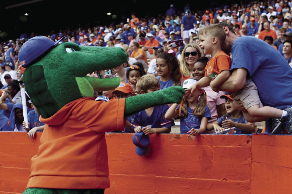 Albert E. Gator greets a young Gator fan during the Orange &amp; Blue football game in January 2019. The scrimmage held at Ben Hill Griffin Stadium had 53,015 in attendance.