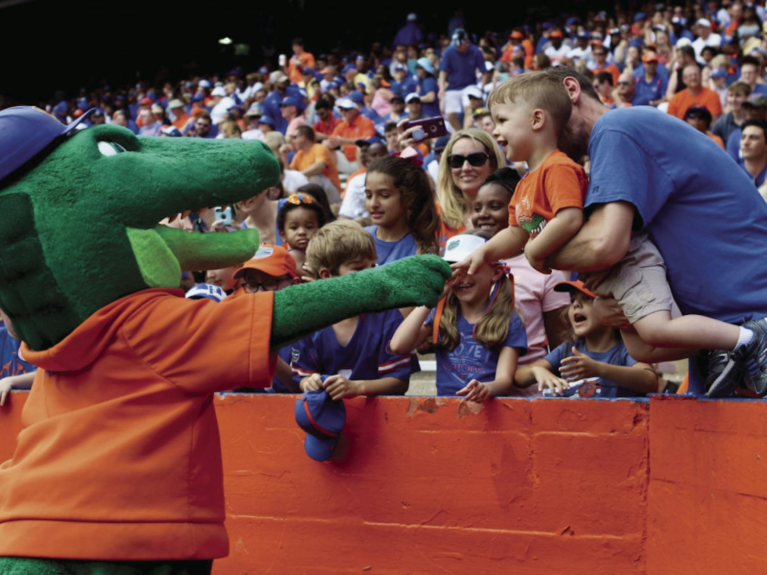 Albert E. Gator greets a young Gator fan during the Orange &amp; Blue football game in January 2019. The scrimmage held at Ben Hill Griffin Stadium had 53,015 in attendance.