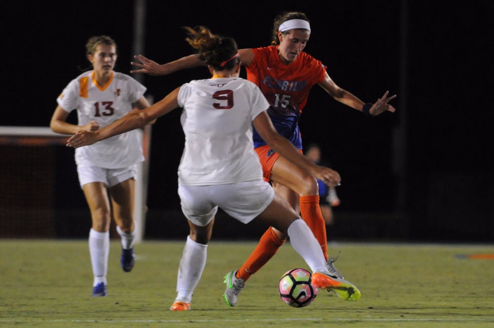 <p>UF midfielder Sarah Troccoli dribbles past an Iowa State defender during Florida's 5-2 win against Iowa State on Aug. 19, 2016, at James G. Pressly Stadium.</p>
